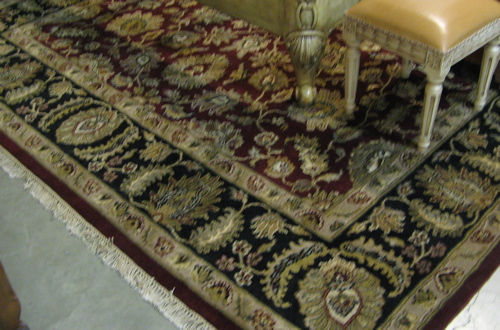 Appraisal: HAND KNOTTED ORIENTAL CARPET overall floral arabesque design on red