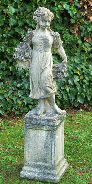 Appraisal: A RECONSTITUTED STONE FIGURE OF A GIRL carrying a basket