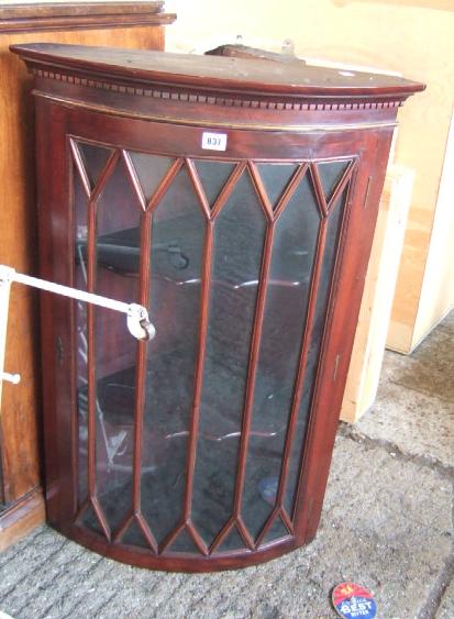 Appraisal: A mahogany bowfront hanging corner cupboard late th century with