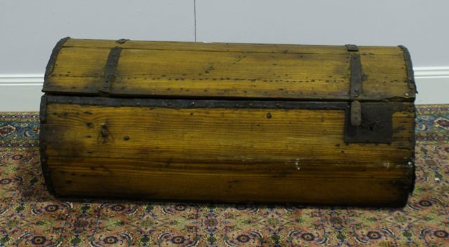 Appraisal: An th century pine and iron bound hinged trunk with