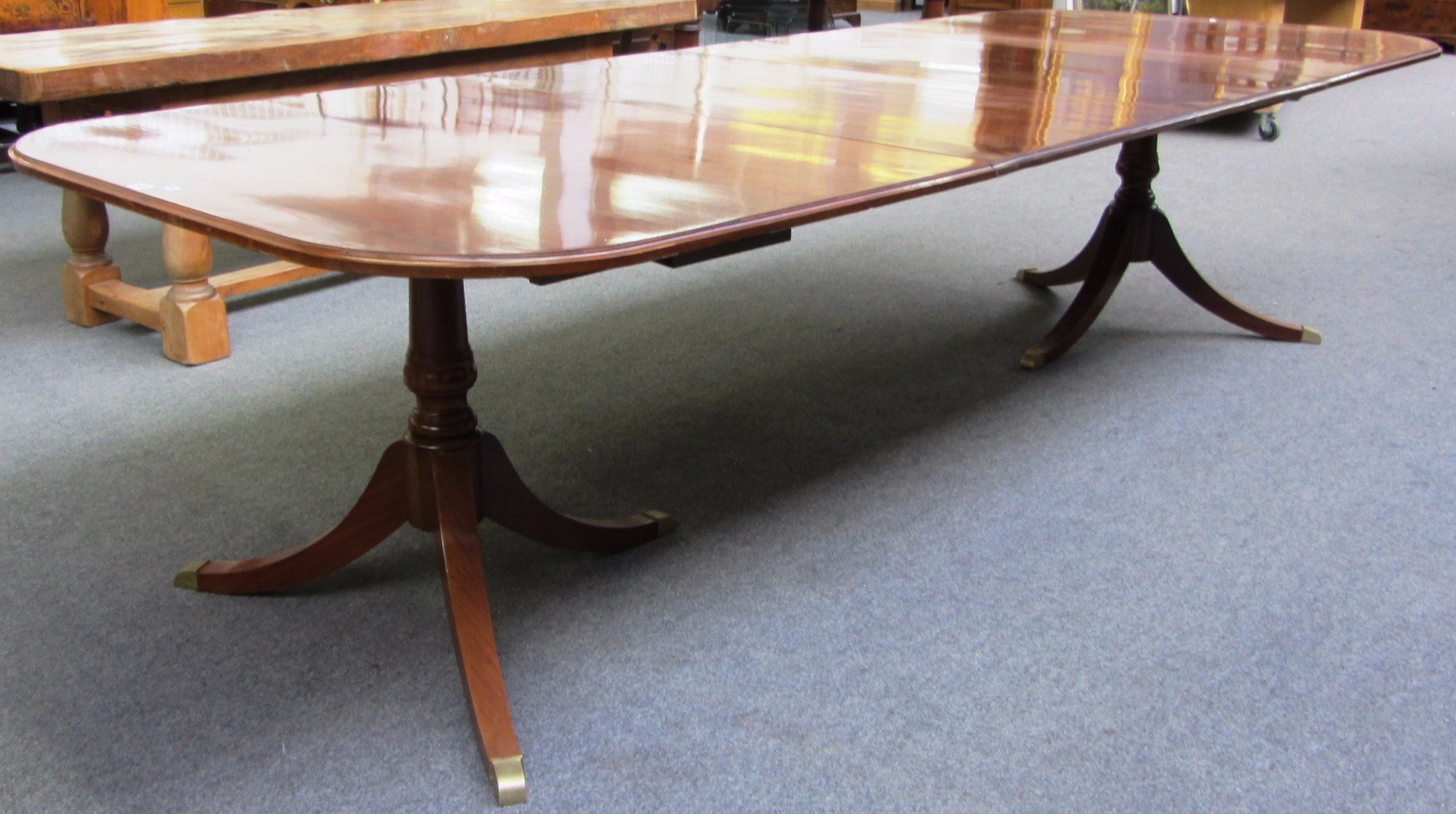 Appraisal: A Regency design mahogany twin pillar extending dining table with