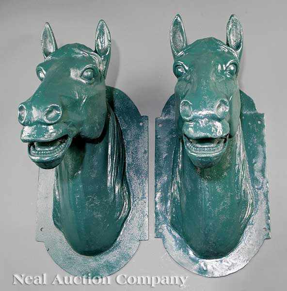 Appraisal: A Pair of Cast Iron Wall-Mounted Horse Heads in green