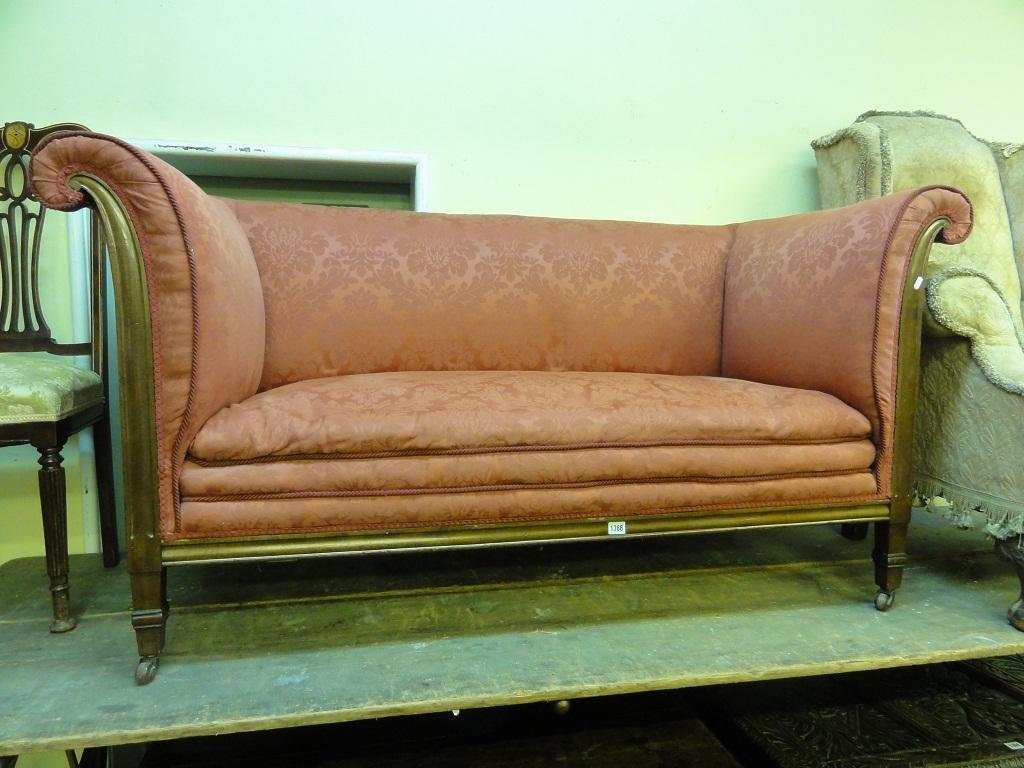 Appraisal: An Edwardian two seat sofa with rolled arms floral upholstery