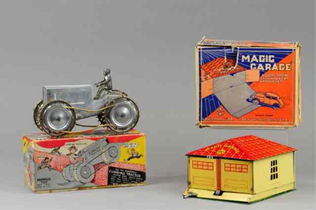 Appraisal: MAGIC GARAGE AND CLIMBING TRACTOR TOY Both boxed litho tin