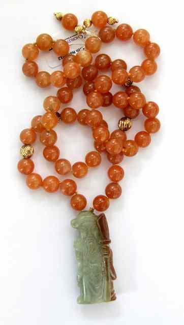 Appraisal: A Chinese single strand necklace of orange beads suspending a