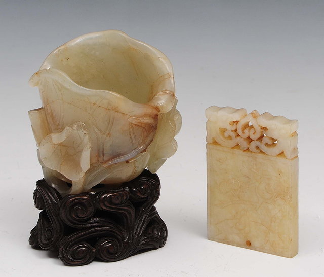 Appraisal: A jade lotus flower vessel th th Centuryon a hardwood