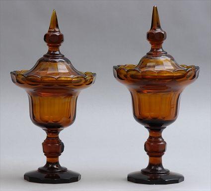 Appraisal: ASSEMBLED PAIR OF CUT AMBER GLASS JARS AND COVERS Each