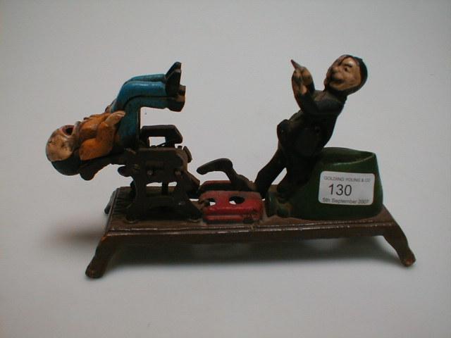 Appraisal: A painted cast iron money box modelled as a dentist