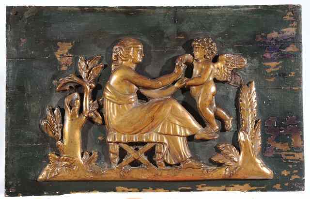 Appraisal: A WOODEN PANEL with applied carved relief figures of a