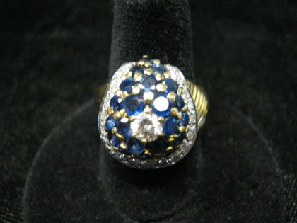 Appraisal: Yellow gold sapphire and diamond cluster ringCenter diamond approximately carats