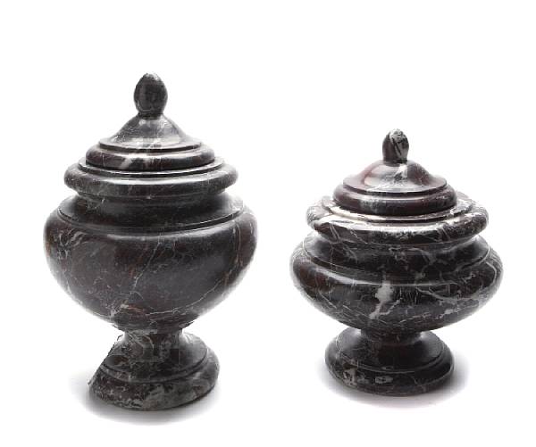 Appraisal: A group of three red Verona marble covered urns height