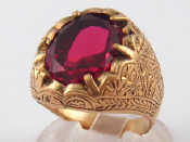 Appraisal: A yellow metal ring set with a red stone marked