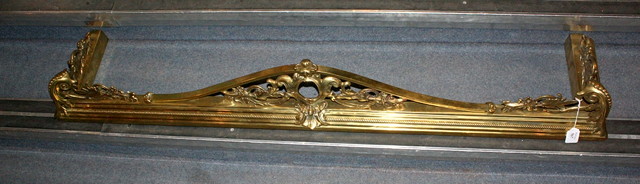 Appraisal: A VICTORIAN HEAVY BRASS FIRE FENDER with foliate swag decoration