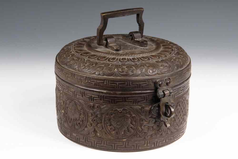 Appraisal: LIDDED ROUND BRONZE BOX-NEPALESE OR TIBETAN-Decorated with raised Buddhist symbols