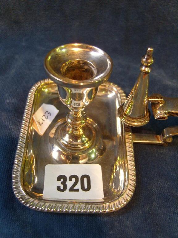 Appraisal: A Georgian style silver chamberstick with shaped handle and gadroon