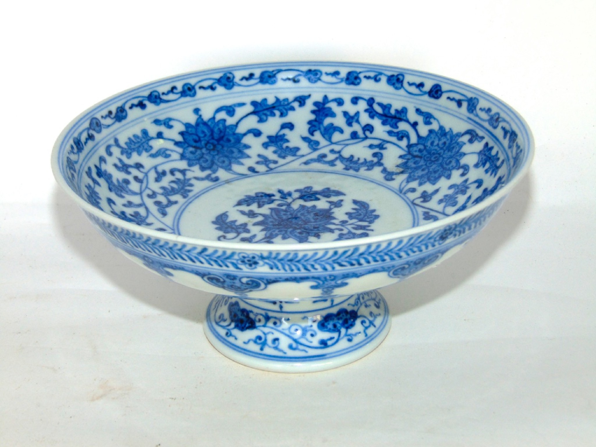 Appraisal: An oriental blue and white stemmed dish with trailing floral