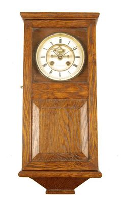 Appraisal: An oak cased wall clock having an eight day movement