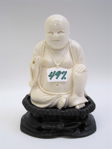 Appraisal: AN IVORY HAND CARVED FIGURE OF BUDDHA SEATED holding prayer