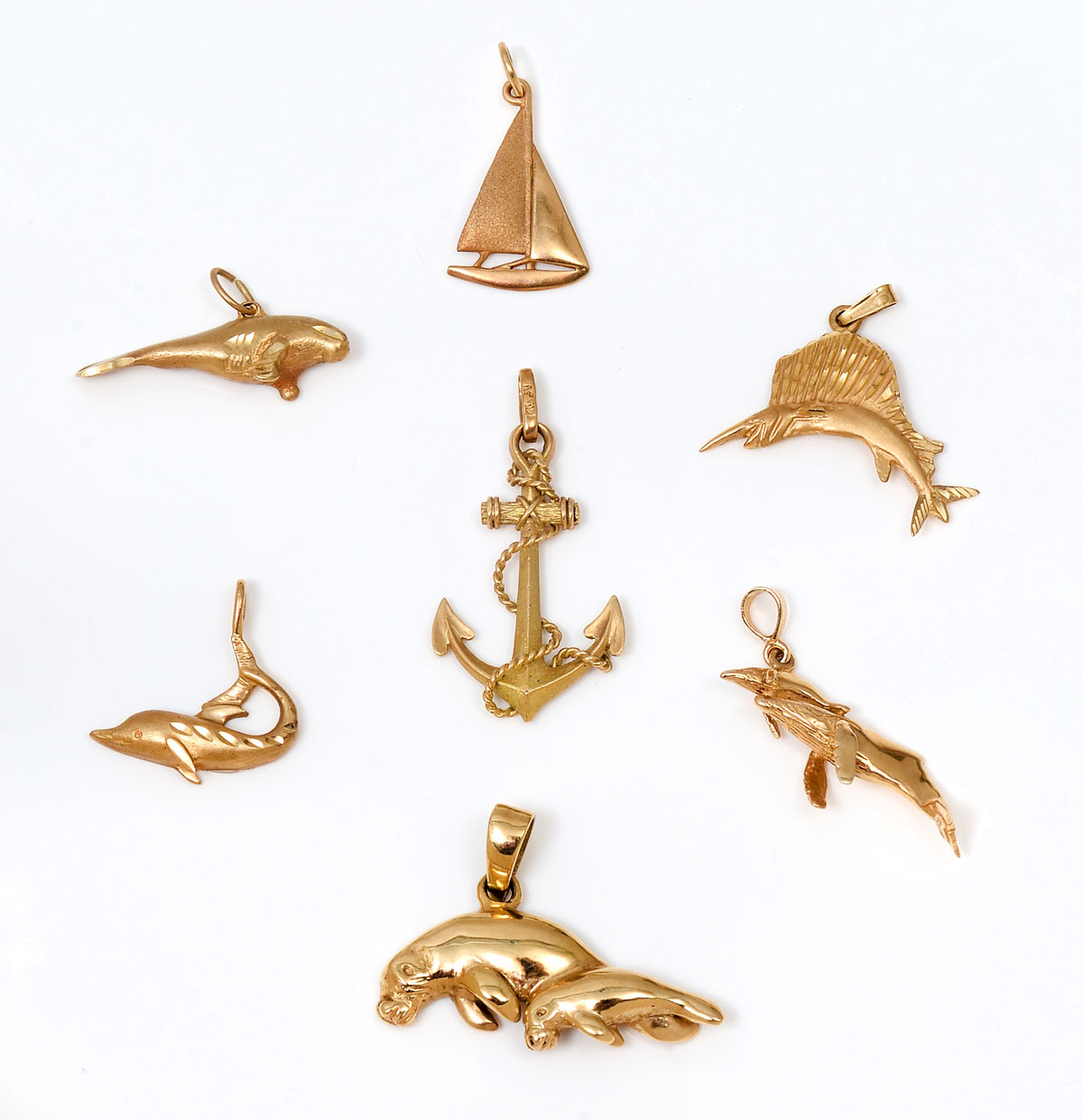 Appraisal: SEA CREATURE CHARMS IN K charms pendants include manatee swordfish