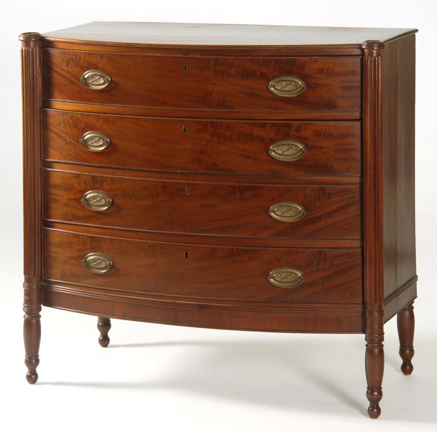 Appraisal: ANTIQUE SHERATON FOUR-DRAWER BOWFRONT CHEST Circa With cookie corners Three-quarter