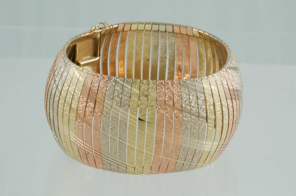 Appraisal: Flexible bangle bracelet in marked K tri-color gold of yellow