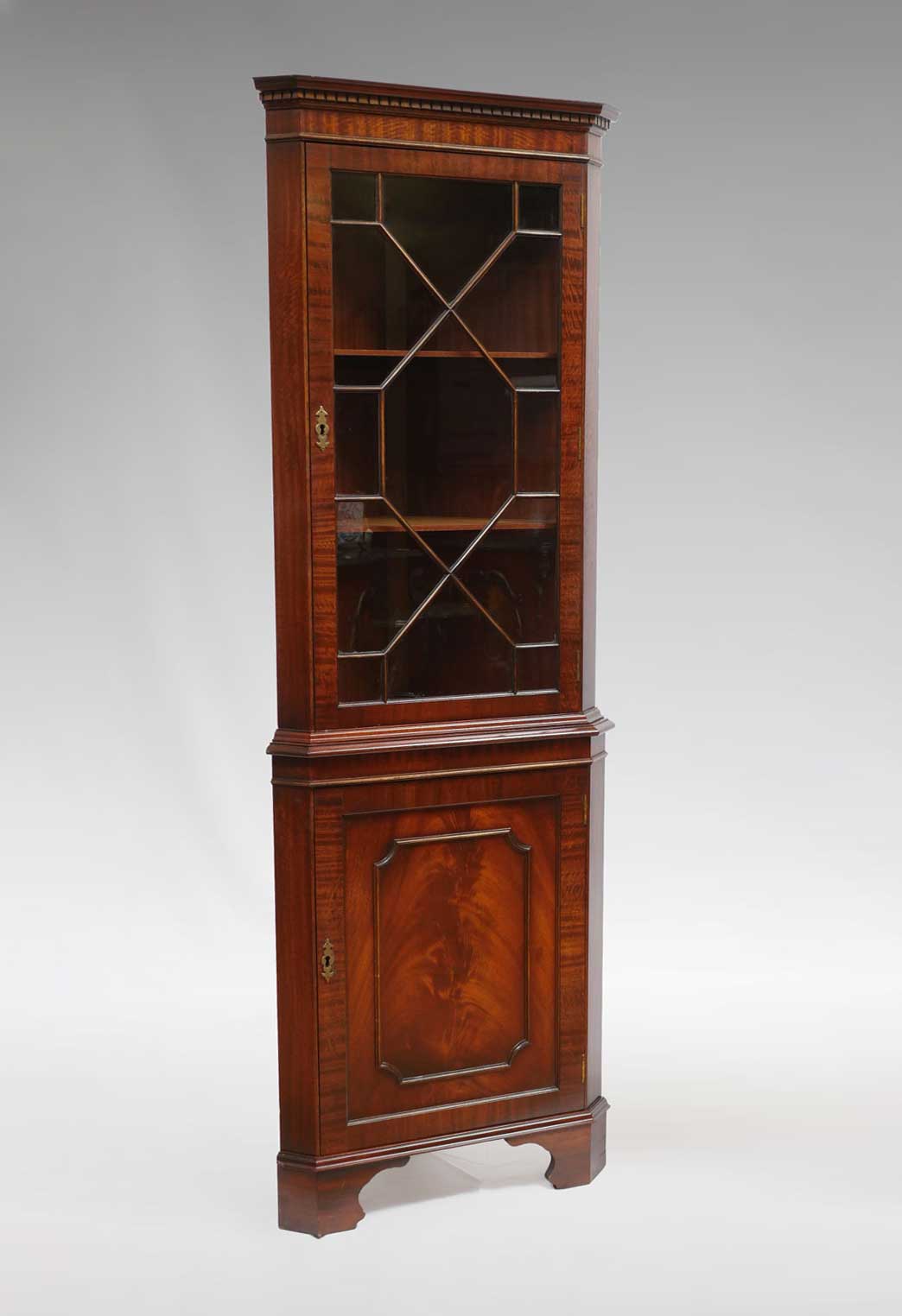 Appraisal: FRETWORK MAHOGANY LIGHTED CORNER CABINET Fretwork corner cabinet having a