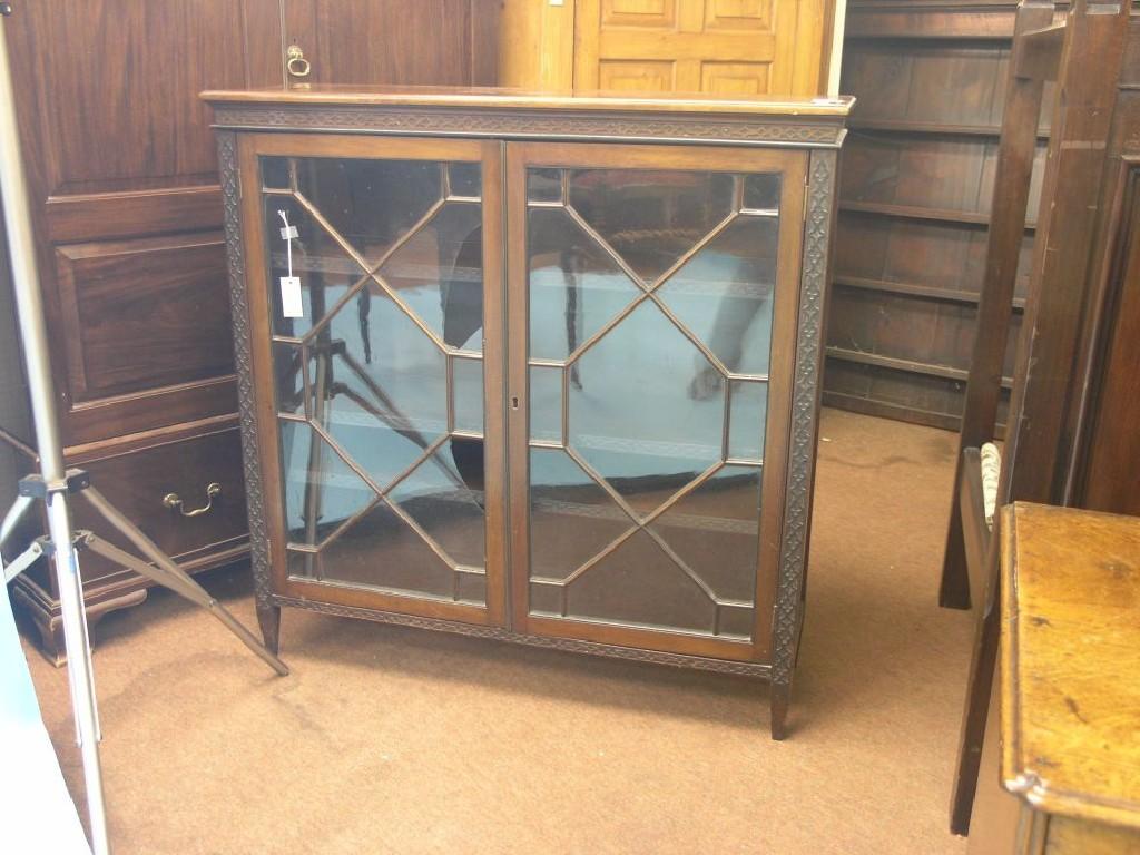 Appraisal: An early th century mahogany bookcase blind-fret detail to frieze