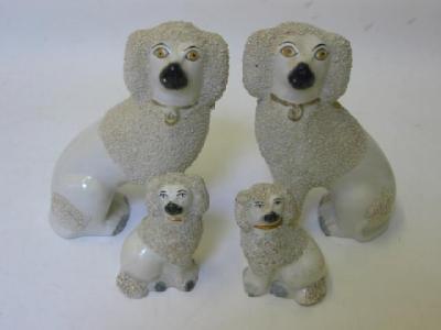 Appraisal: A PAIR OF STAFFORDSHIRE POTTERY POODLES late th century modelled