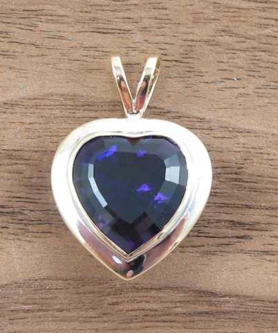 Appraisal: AMETHYST AND FOURTEEN KARAT GOLD PENDANT set with a heart-cut