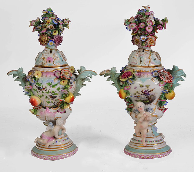 Appraisal: A PAIR OF CONTINENTAL PORCELAIN FLOWER DECORATED VASES and covers