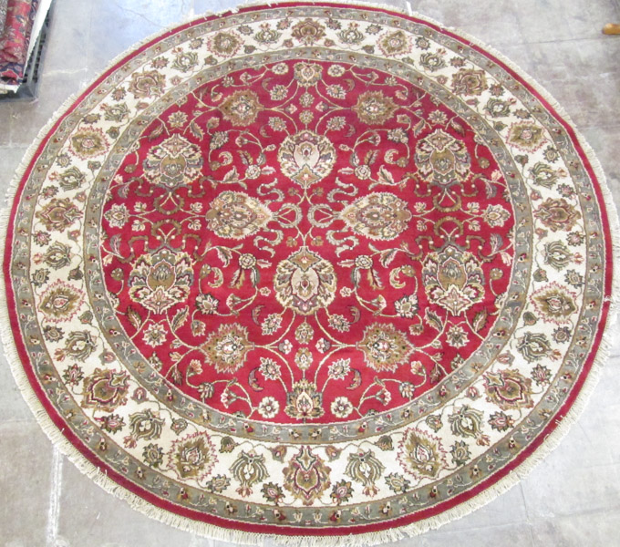 Appraisal: ROUND ORIENTAL CARPET Indo-Persian overall floral design on red ground