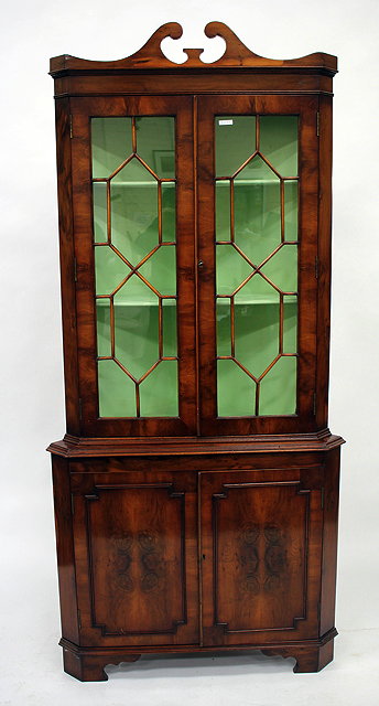 Appraisal: A REPRODUCTION YEW WOOD VENEERED CORNER CABINET with astral glazed