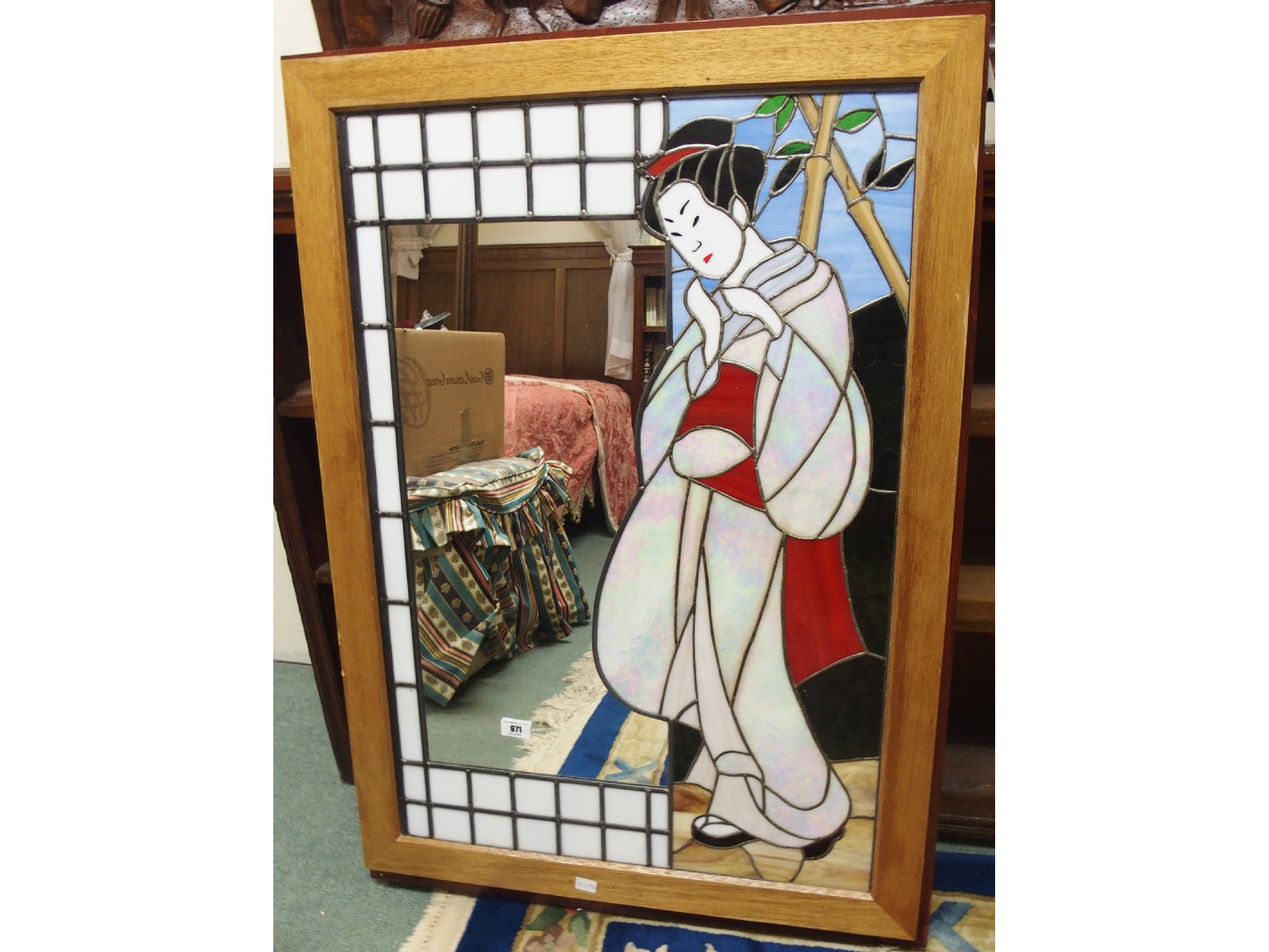 Appraisal: A leaded and stained glass mirror with geisha