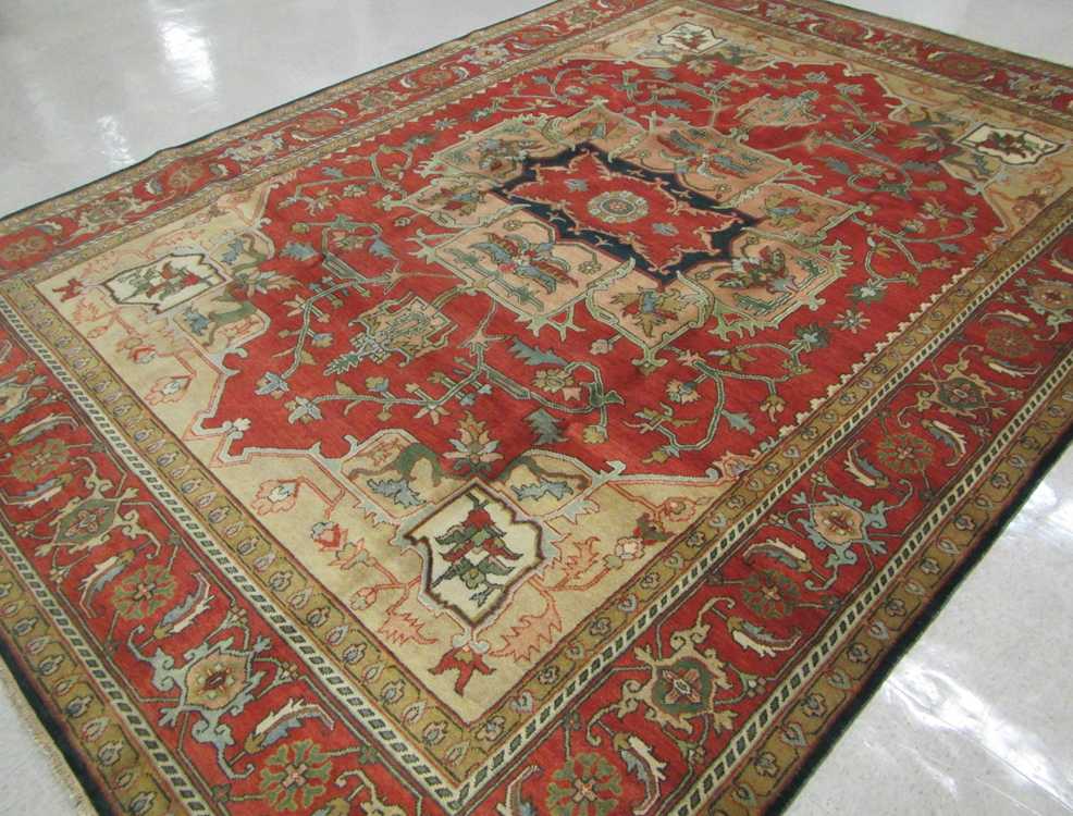 Appraisal: HAND KNOTTED ORIENTAL CARPET Indo-Serapi central geometric medallion and stylized