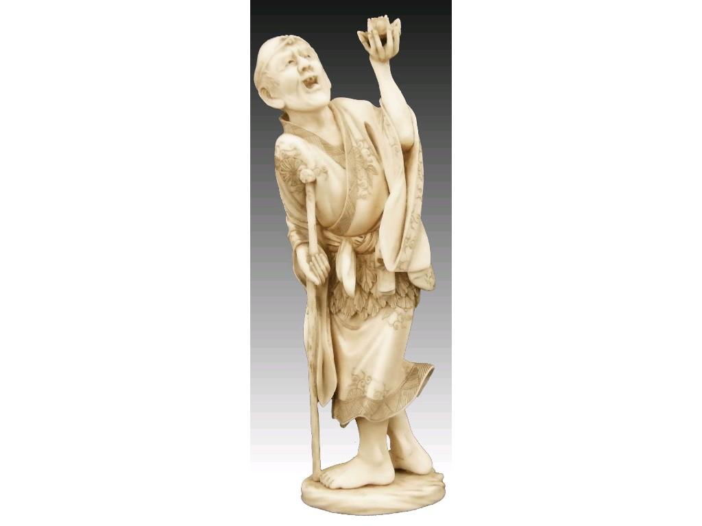 Appraisal: Japanese ivory okimono of an elderly fisherman wearing an engraved