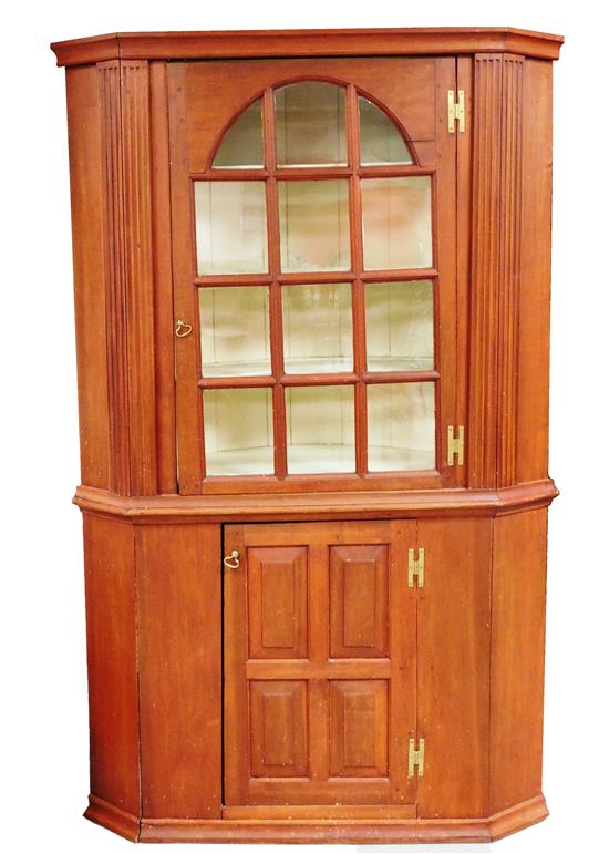 Appraisal: th th C single piece barrel back corner cabinet cherry