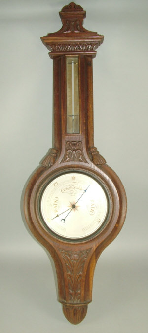 Appraisal: An early th century carved oak wheel barometer with silvered