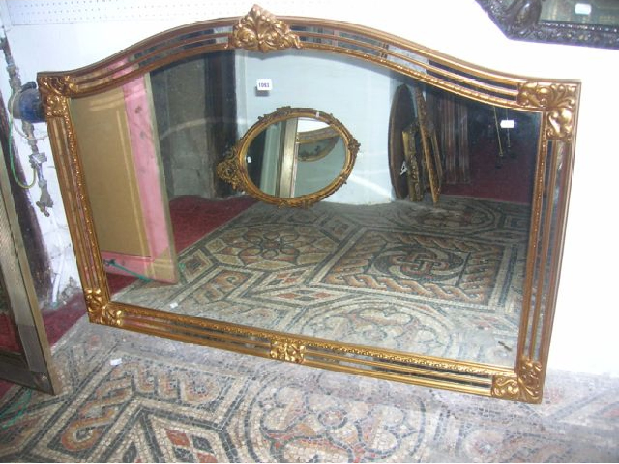 Appraisal: A contemporary reproduction overmantle mirror of rectangular and arched form