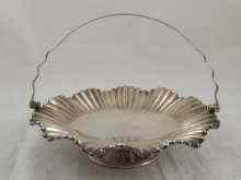 Appraisal: A silver plated fluted swing handle cake basket approx cm