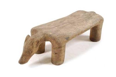 Appraisal: An African carved wood low stool modelled as an animal