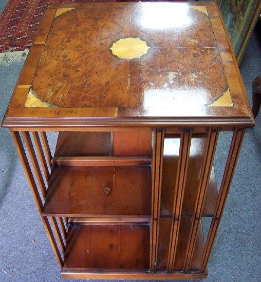 Appraisal: A revolving bookcase the square top with central fan inlay