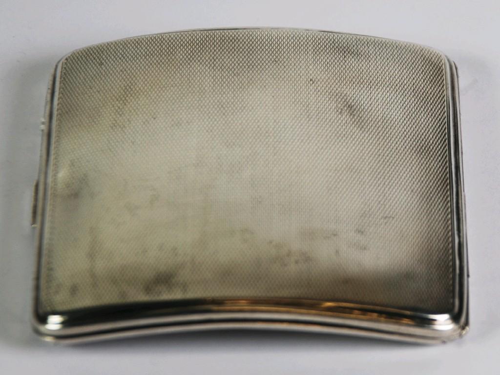 Appraisal: SILVER POCKET CIGARETTE CASE slim curved oblong with engine turned