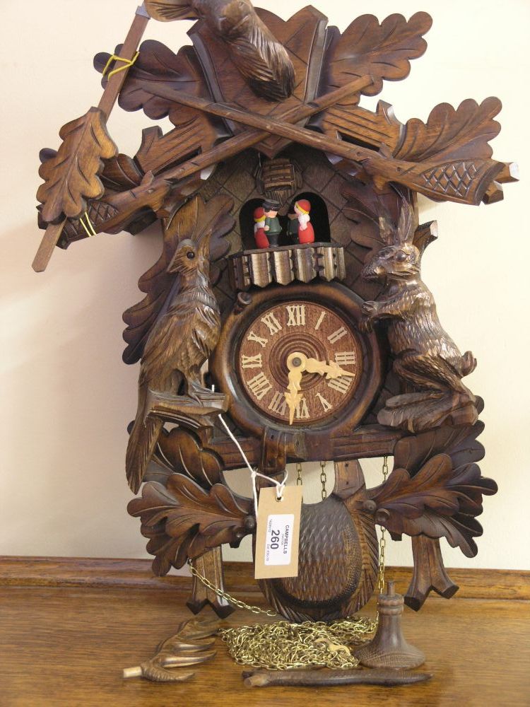 Appraisal: A modern Swiss carved wood cuckoo clock in - with