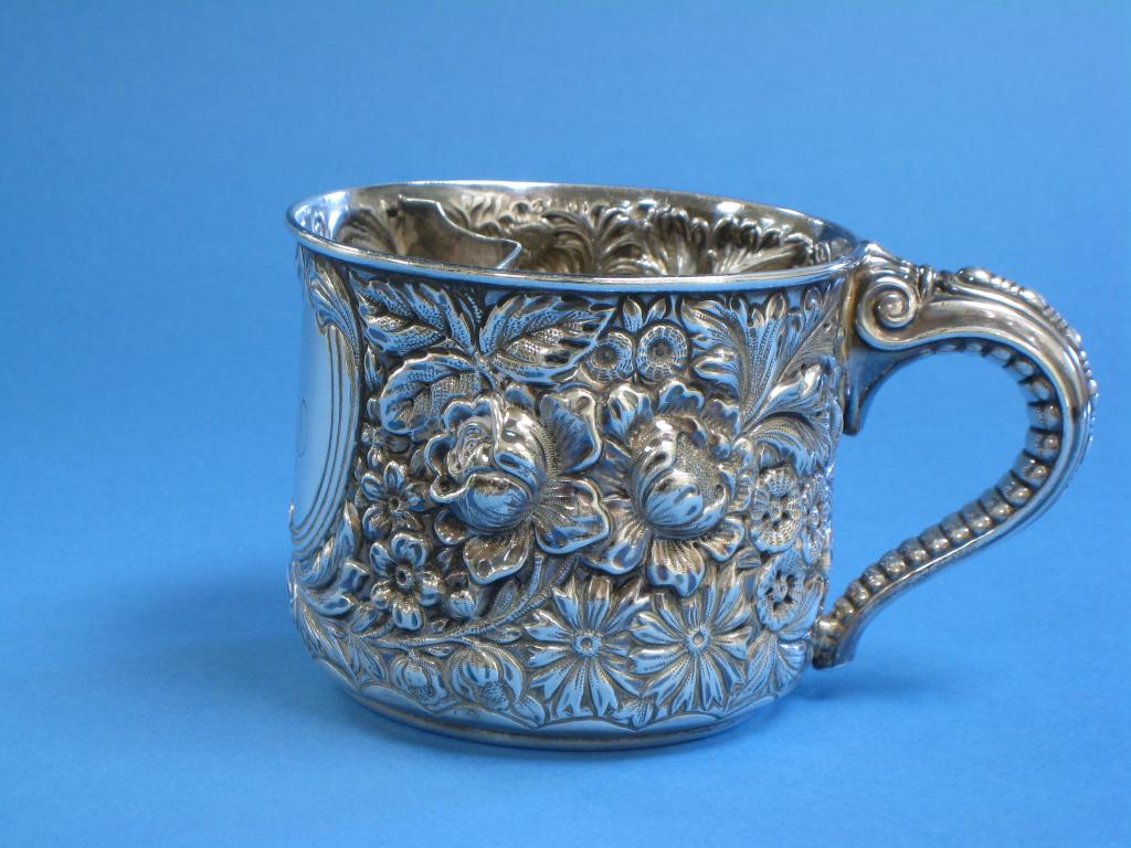 Appraisal: A sterling silver Shaving Mug with floral embossing and shaped