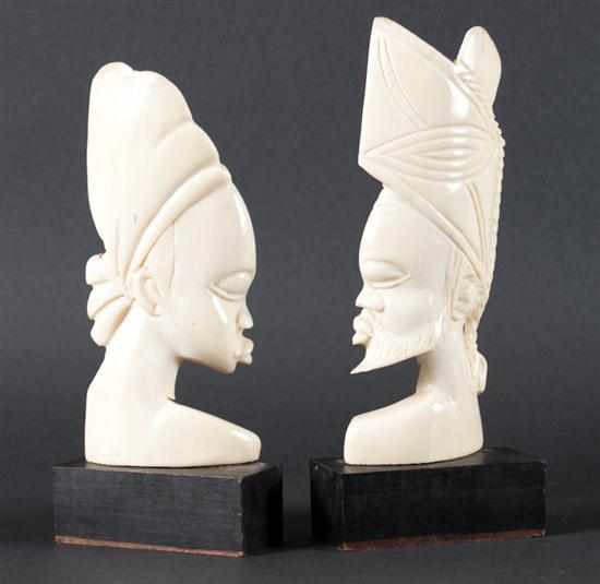 Appraisal: Two African carved ivory portrait busts of a man and