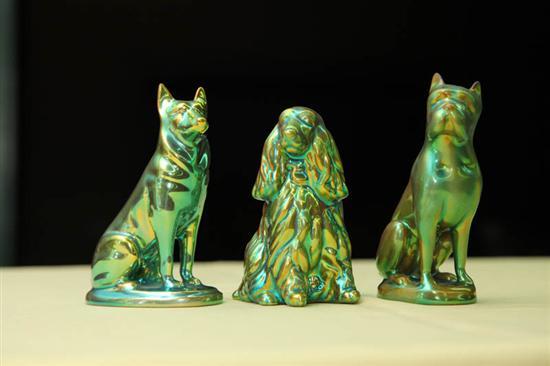 Appraisal: THREE ZSOLNAY DOG FIGURES A bulldog h A terrier h