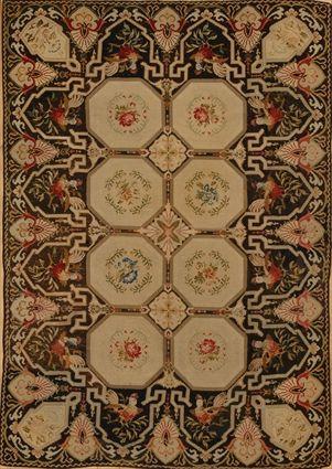 Appraisal: TWO NEEDLEWORK RUGS Each black ground the one with floral