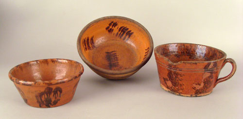 Appraisal: Pennsylvania redware mush mug ca dia together with bowls dia