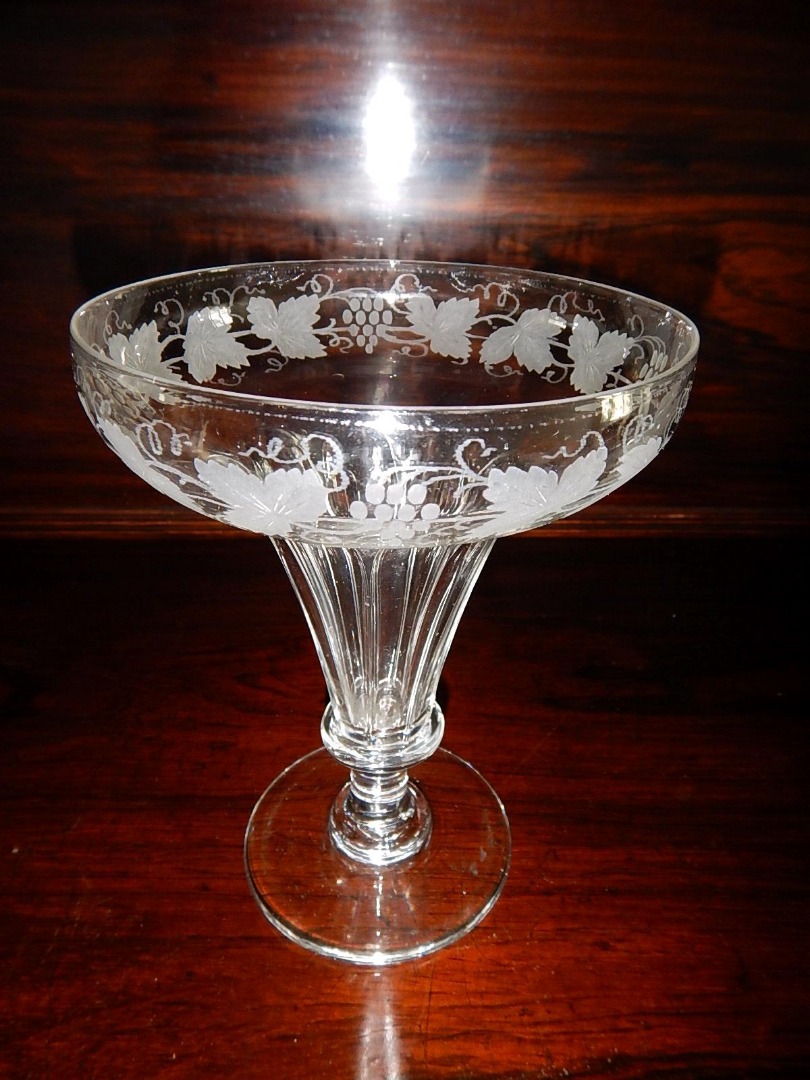 Appraisal: A thC trumpet shaped pedestal glass engraved with fruiting vine