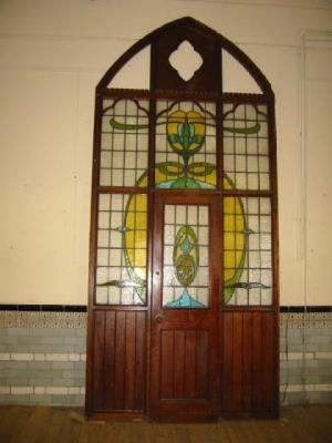 Appraisal: A PITCH PINE LEADED STAINED GLASS DOORWAY of pointed arch